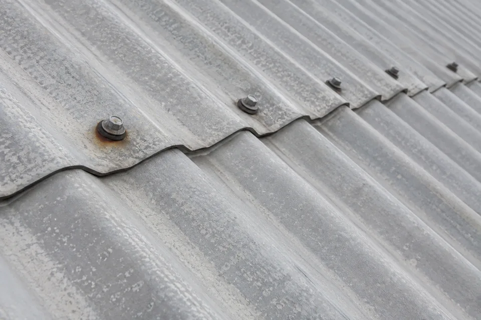 Weathered metal roof sheets with an overlap and existing fasteners