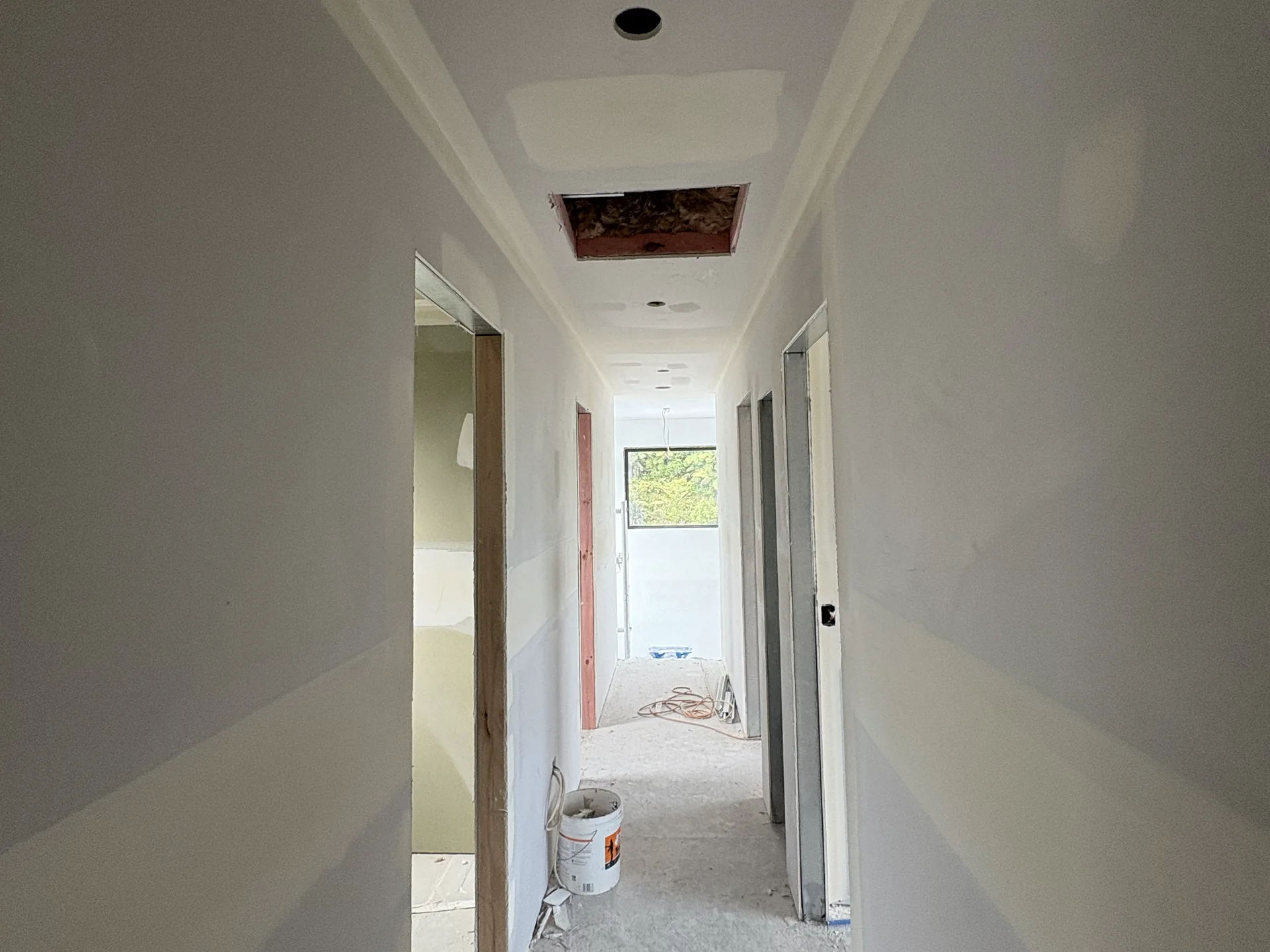Hallway wall preparation and sanding for a smooth paint finish